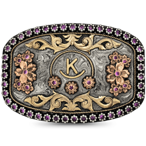 A custom belt buckle for women featuring an initial bronze figure, flowers and scrolls, framed by pink zirconia berries